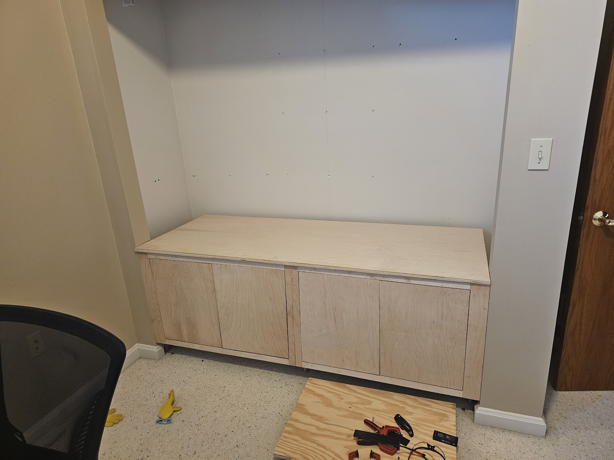 Completed base cabinet with four inset doors and a solid top surface