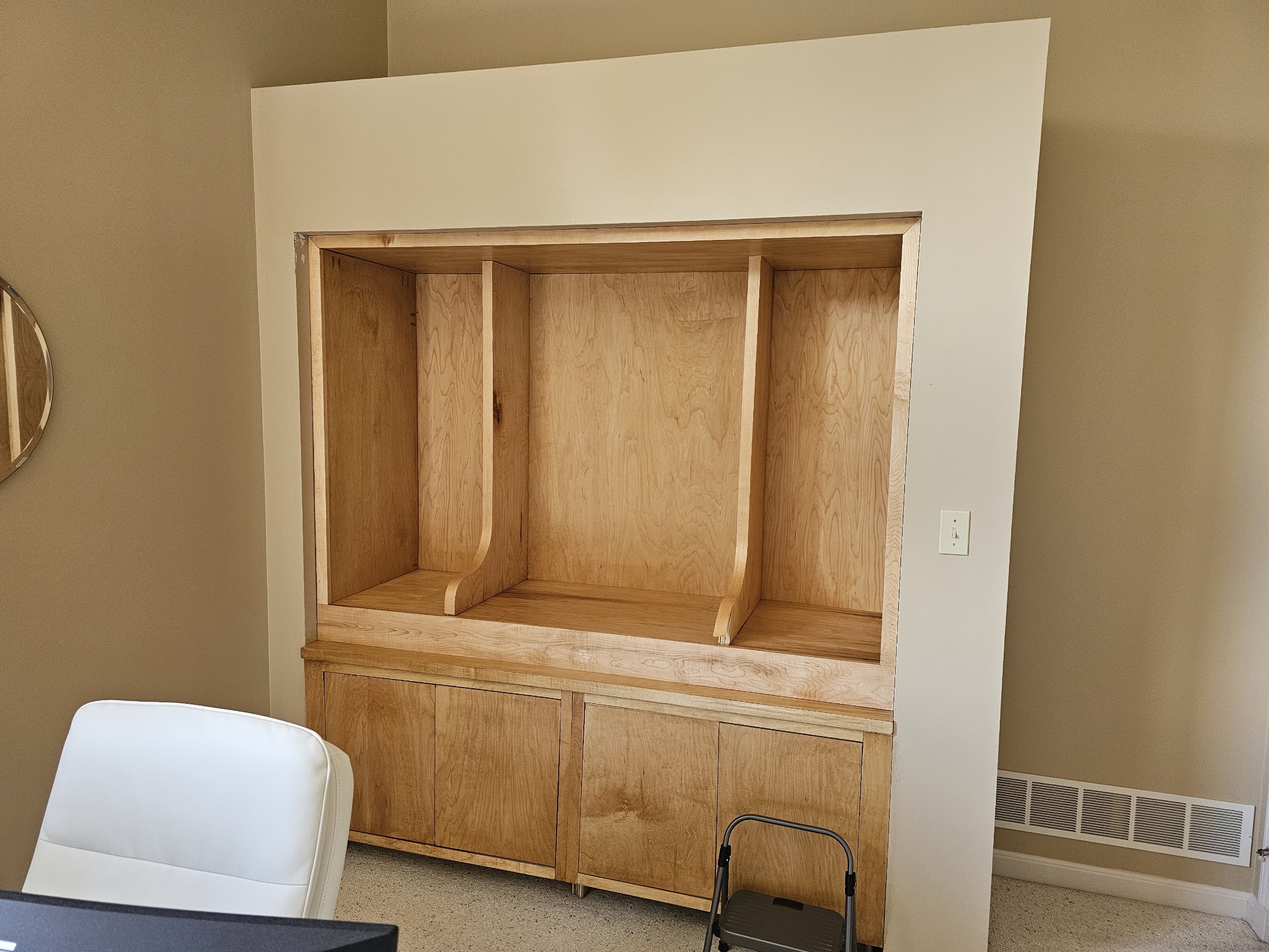 Finished stained built-in with curved verticals and no shelves or decor yet